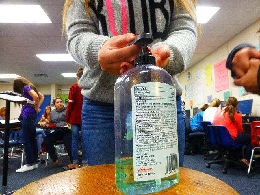 Students+sanitizes+her+hands+in+Ms.+Thomas%E2%80%99+room%2C+with+an+almost+empty+hand+sanitizer.
