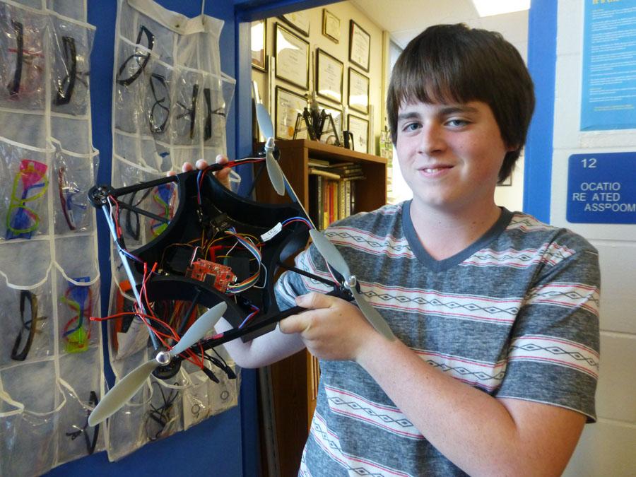 Victor Alva, a sophomore in engineering, holds up their original quadcopter design similar to what Amazon intends to use for its delivery service