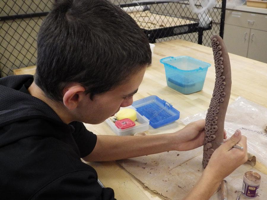 Sam Generalli works on an octopus for the courtyard installment.