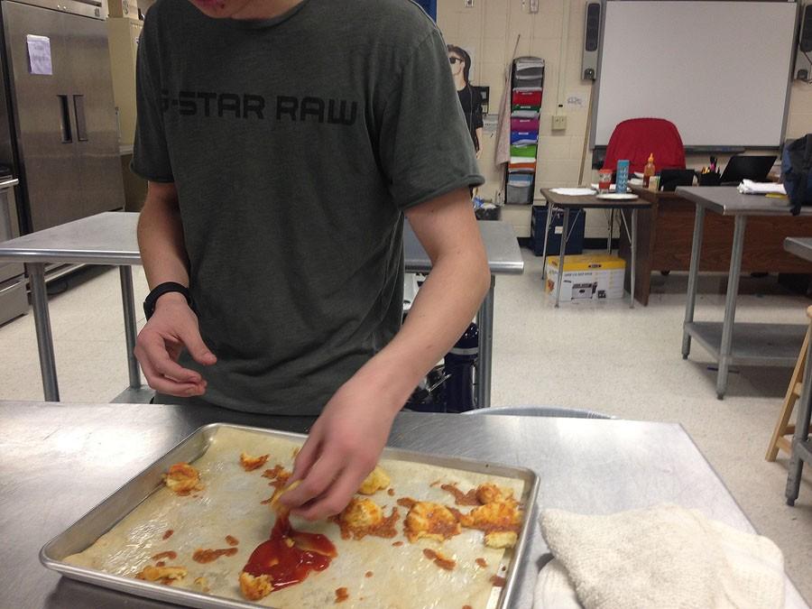 A student prepares Duchess Potatoes, one of the many dishes that will be served at Monday's dinner.