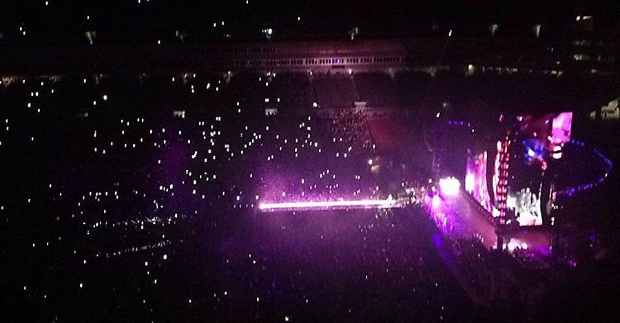 The stage lights up purple as the crowd sings 'Purple Rain' along with Beyonce to honor Prince.