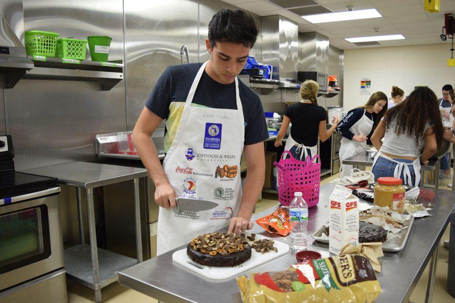 Culinary students compete to see who can make the best  cake.