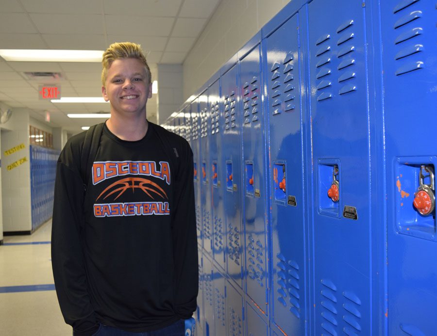 Adam Sweirenga wears his basketball team shirt on the first game day of the season. 