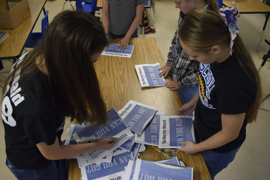 Staff members get the newspaper ready for distribution.