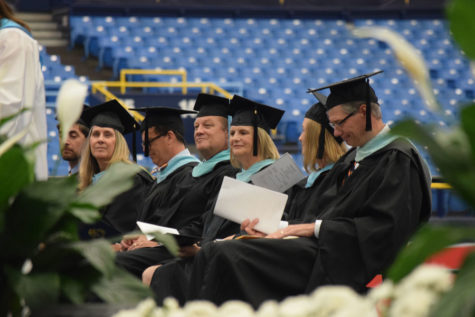 Teachers and staff  watch as seniors graduate at the 2021 graduation ceremony at Tropicana Field.