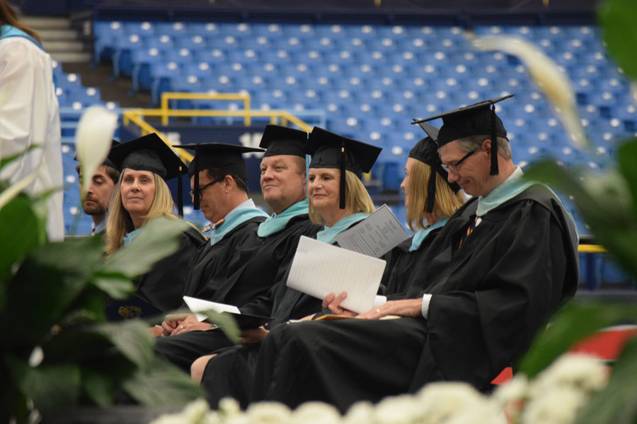 Members of the administration and faculty watch as seniors graduate at the 2023 graduation ceremony at Tropicana Field.