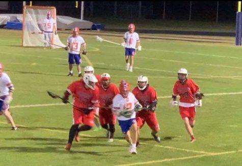 Ryan Kinnear is running down the field during a game last season against Clearwater High School at the Warriors Stadium. He's on a fast break.