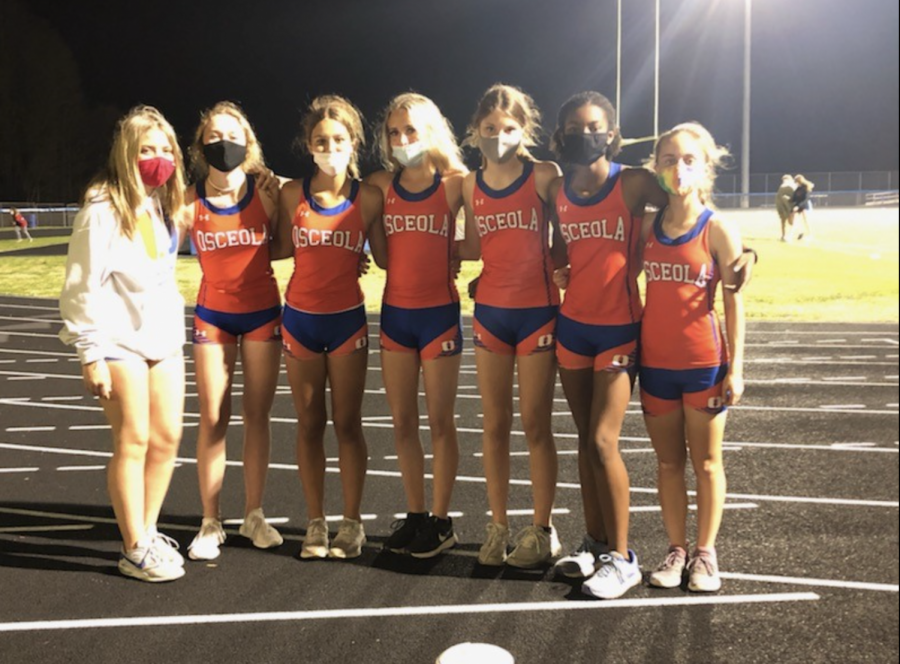 Lauren Wiseman, Kylie Houck, Marissa Eckel, Ryan Fair, Emma Perez, India Nichols, and Elle Mehltretter gather for a quick pic after a track meet. 