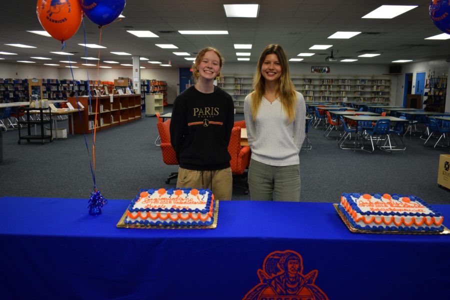 Elizabeth and Gabija Posing behind their cakes.