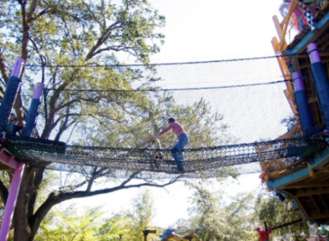 A mother and her child playing in a rope playground. Photographer unknown.