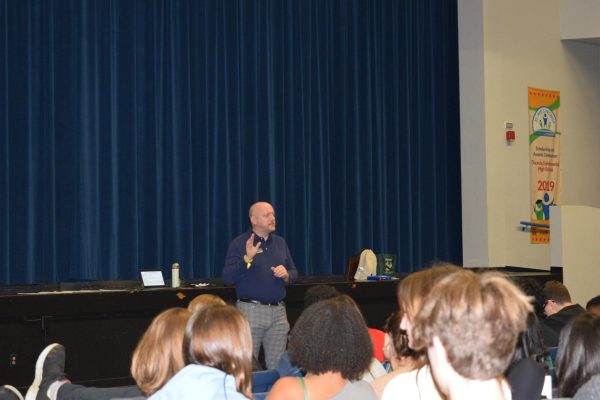  Professor Herron informing students about college.