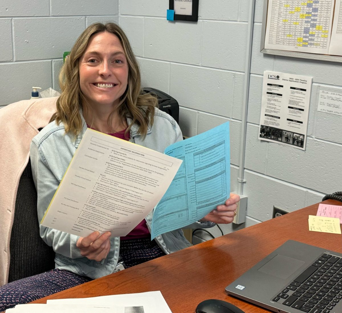 9th grade guidance counselor Mrs. Havekotte holds up the elective papers.