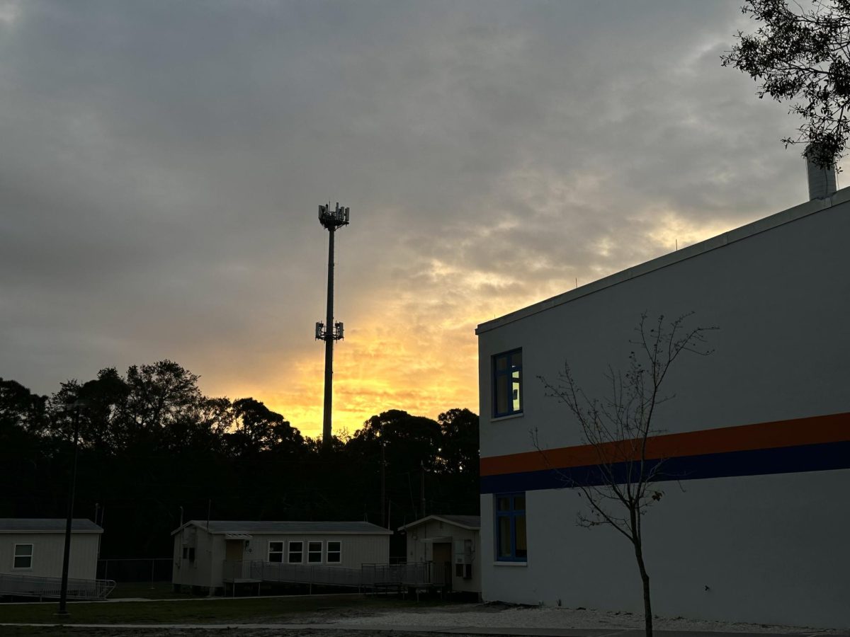 On January 18th, 2024 the sun slowly rises above the Osceola rooftop with winter clouds in view.