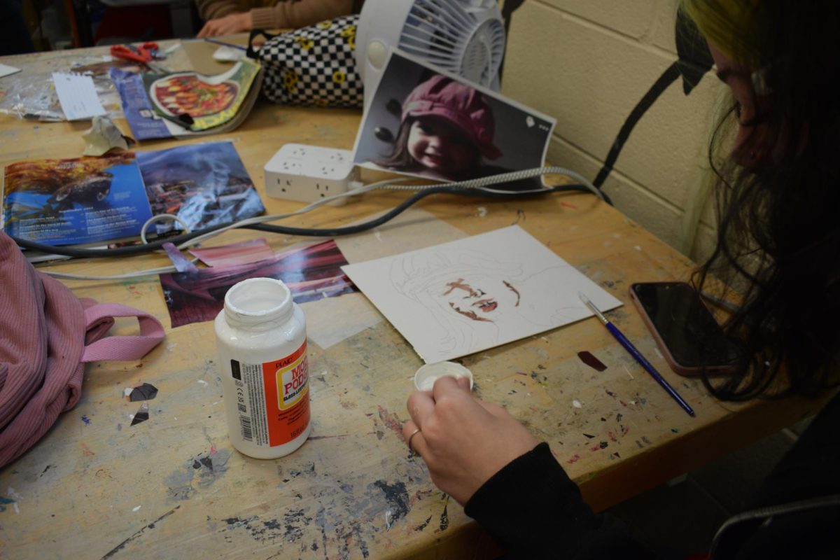 Mrs. Gates art class making Mosaics with  pieces of newspapers.
