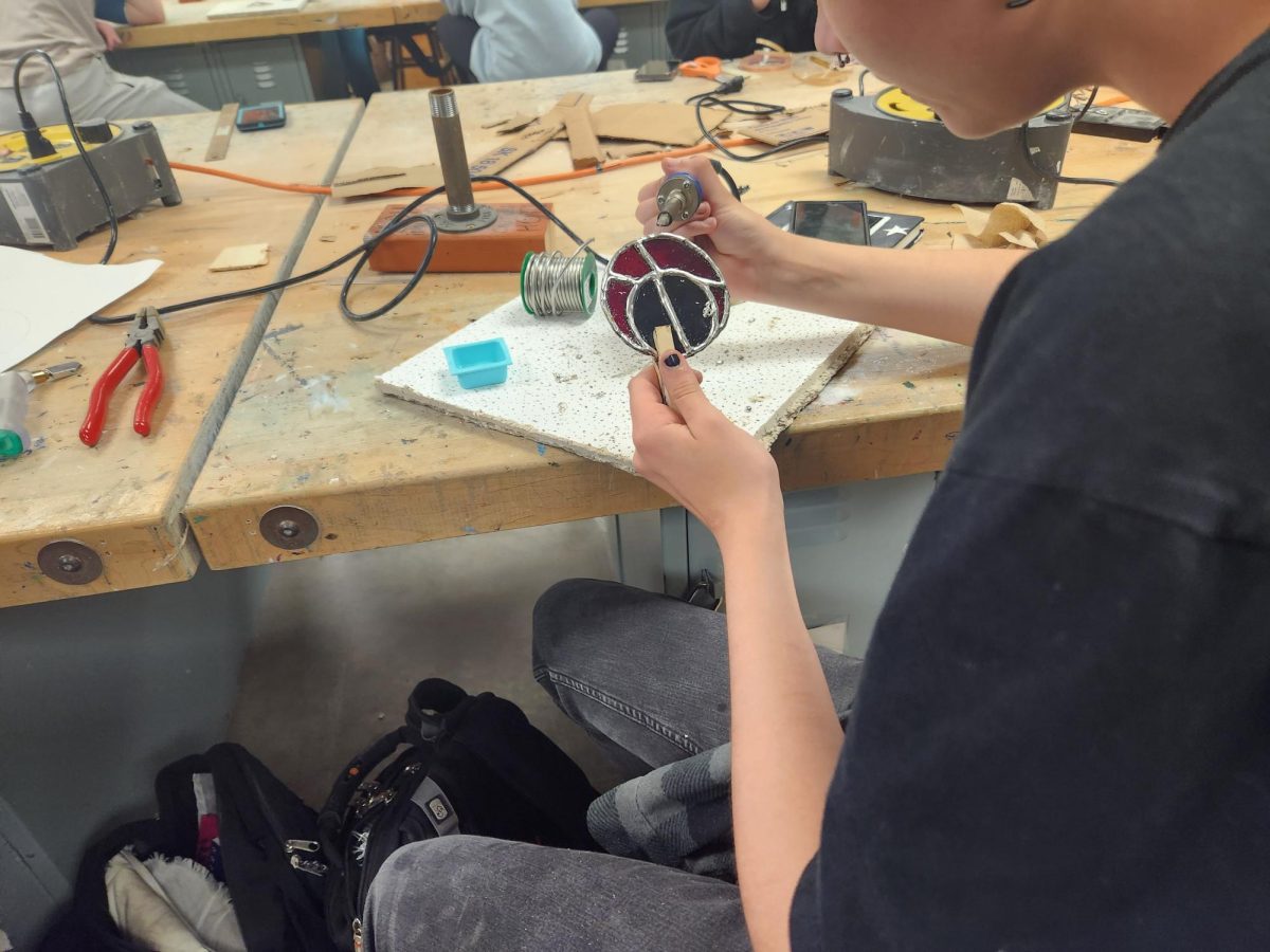 A student in Mrs. Gates class soldering on Wednesday, May 1st during 3trd period