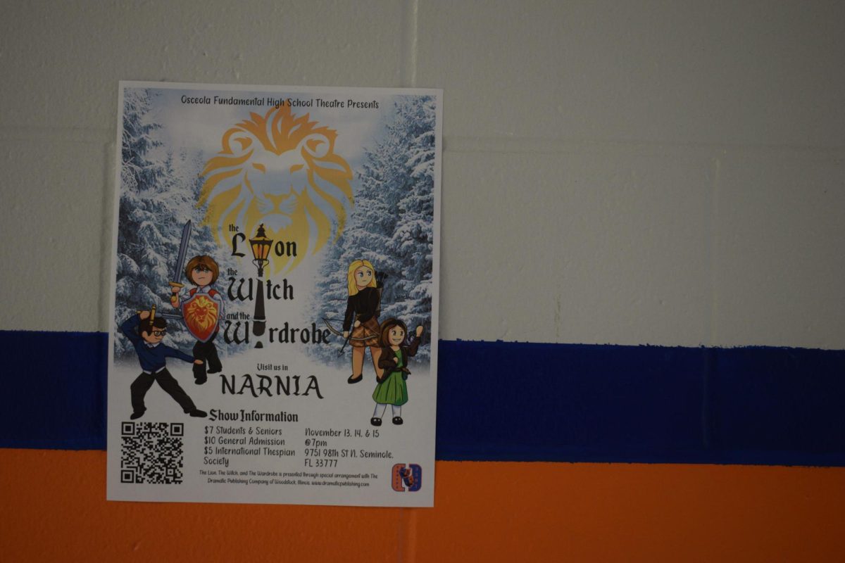 Flyers for "The Lion The Witch and the Wardrobe" are hung around campus, displaying information. 