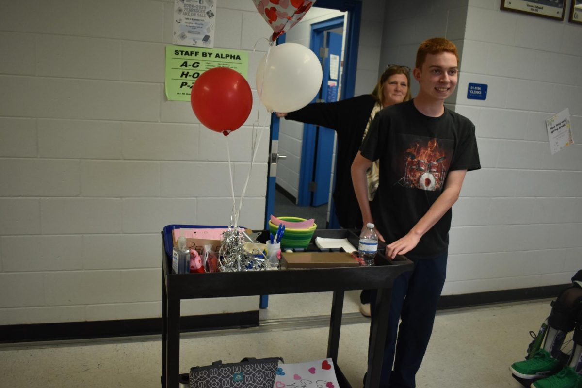 A student wheels the sales cart back to the classroom in order to count the sales for the day.