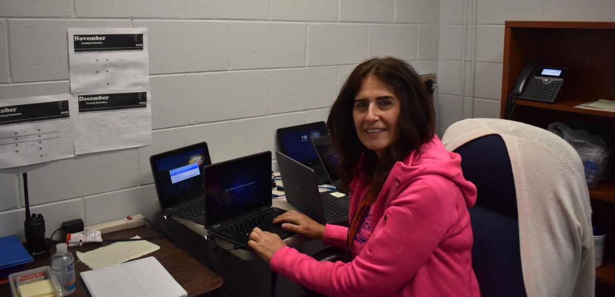 Ms. Carroll always is hard at work trying to fix student laptops!
